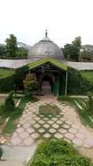 Entrance gate of Company Bagh showing a structure with arches and trees in the background