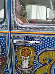 Detailed view of Huichol art on Volkswagen Beetle door