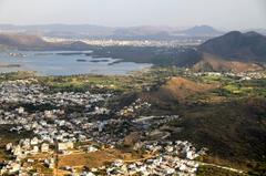 Aerial view of Udaipur city and lakes surrounded by Aravalli mountains in Rajasthan, India