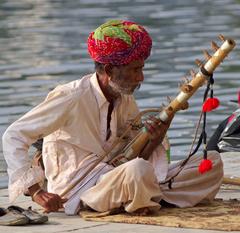 street musician on the bank of Pichola Lake in Udaipur