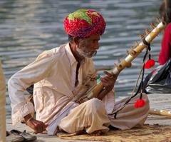 Street musician on the bank of Pichola Lake in Udaipur