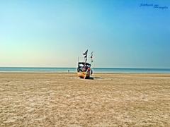 Sunny beach with footprints and clear blue sky