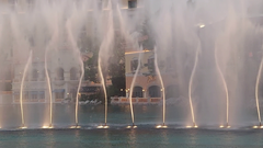 Fountains of Bellagio at night with illuminated water jets