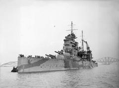 British battleship HMS Queen Elizabeth moored in the Forth with the Forth Railway Bridge in the background