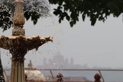 fountain at Jaswant Thada with a faded view of Umed Bhawan palace