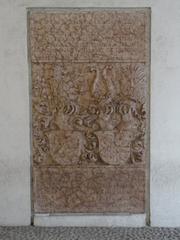 Headstone at the entrance of buildings annexed to Palazzo Thun in Trento, Italy