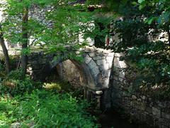 small bridge in Chancelade Abbey park over Beauronne arm