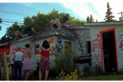 teenagers on roof of graffiti house in Invermere, British Columbia