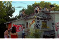 teenagers on roof of graffiti house in Invermere, British Columbia