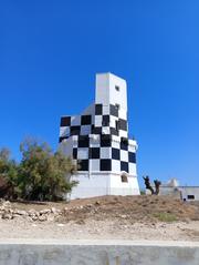 Lighthouse at Torre San Giovanni in Ugento on a sunny day with blue sky