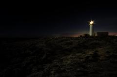 Faro di Capo Murro di Porco lighthouse on rocky cliff