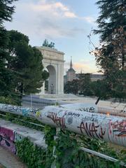 Arco de la Victoria in Madrid with graffiti and vegetation