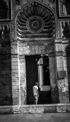 A young man enters the mosque