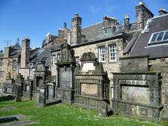 East wall of Greyfriars Kirkyard with old stone architecture and greenery