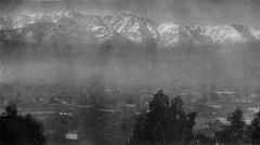 Crest of the Andes mountains above the evening mist from Santiago, Chile