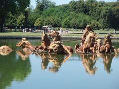 Bassin d'Apollon in a garden with a large statue and pond