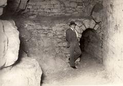 Man at the end of the catacomb tunnels in Paris, France, 1929