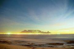 Table Mountain at night viewed from Bloubergstrand