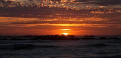 Blouberg sunset with the orange and pink hues reflecting over the calm ocean