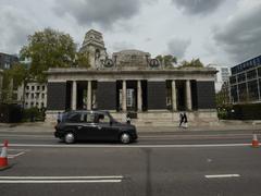 black cab passing Tower Hill Memorial pavilion