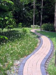 Queens Park near Jartujak Park with lush greenery and a serene pathway