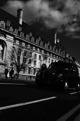 classic black cab driving through London