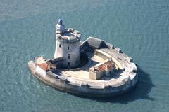 Fort Louvois in France from a distance with calm waters surrounding it