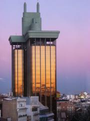 Torres Colón and Spanish flag at sunset