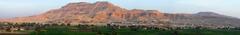 Panoramic view of the Nile westbank at Luxor at dawn featuring notable landmarks such as the Colossi of Memnon, the Ramesseum, Hatshepsut's temple, and the village of Sheikh Abd el-Qurna.