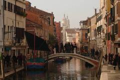 Scenic view of Venice canal with boats and historic buildings