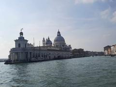 A scenic view of a canal in Venice, Italy, with gondolas and historic buildings