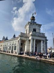 a scenic view of Venice, Italy with boats on the canal and historic buildings