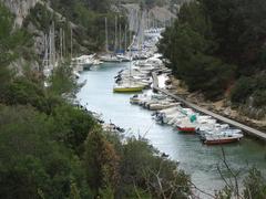 View of Calanque de Port-Miou with rocky cliffs and clear blue water in Bouches-du-Rhône