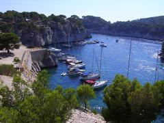 A panoramic view of Calanque Cassis with rocky cliffs and blue sea under a clear sky