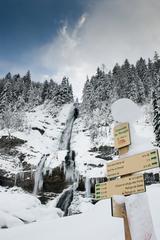 Frozen Cascade du Rouget waterfall in winter