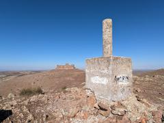 Geodesic vertex of Cerro del Buen Vecino with Almonacid de Toledo castle in the background