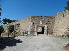 Historic main gate to Citadel with stone walls and towers