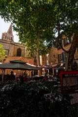 panoramic view of Place du Cloître-Saint-Pierre in Avignon with Basilique Saint-Pierre in the background displaying Gothic architecture