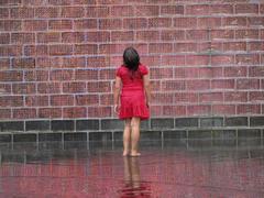 Child staring up at tower of Crown Fountain in Millennium Park, Chicago