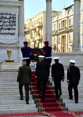 Distinguished visitors render salutes at a wreath laying ceremony at the Unknown Soldier Monument in Alexandria, Egypt