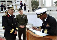 Cmdr. Eric Cash signing a guest log with Lt. Col. John Giltz and Egyptian Navy Cmdr. Ghanem Tarek observing