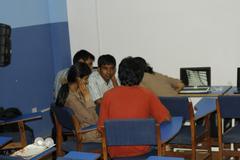 people working on laptops at a tech event