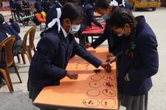 Children playing Gauchali game with marbles