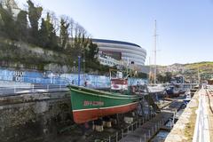 Scenic view of Bilbao with a boat cruising through the river