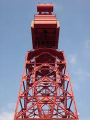 Red crane in Bilbao with a blue sky backdrop