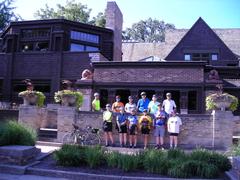 Cyclists group outside Frank Lloyd Wright Home and Studio