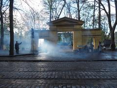 Film crew in front of the main gate of the church park, with the Old Church visible through the gate