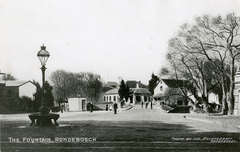 Main Road Rondebosch street scene with Rondebosch Fountain in the foreground, circa early 1900s