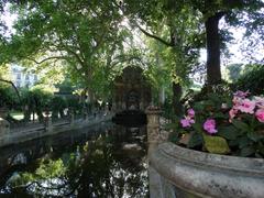 Fontaine Medicis water feature with historic sculptures and lush greenery