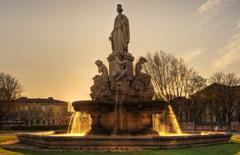 Esplanade Charles de Gaulle in Nîmes, France, featuring a vibrant public square with fountains and trees